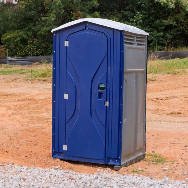 Standard portable toilets lined up outdoors